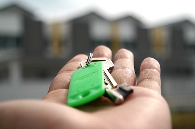 Hand holding house keys on keyring