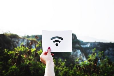 Woman holding up a WiFi sign