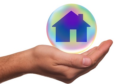 Hand holding a house in a sphere