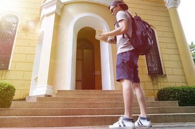 Student reading in front of a property