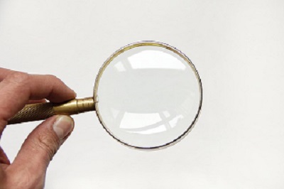 Man holding magnifying glass