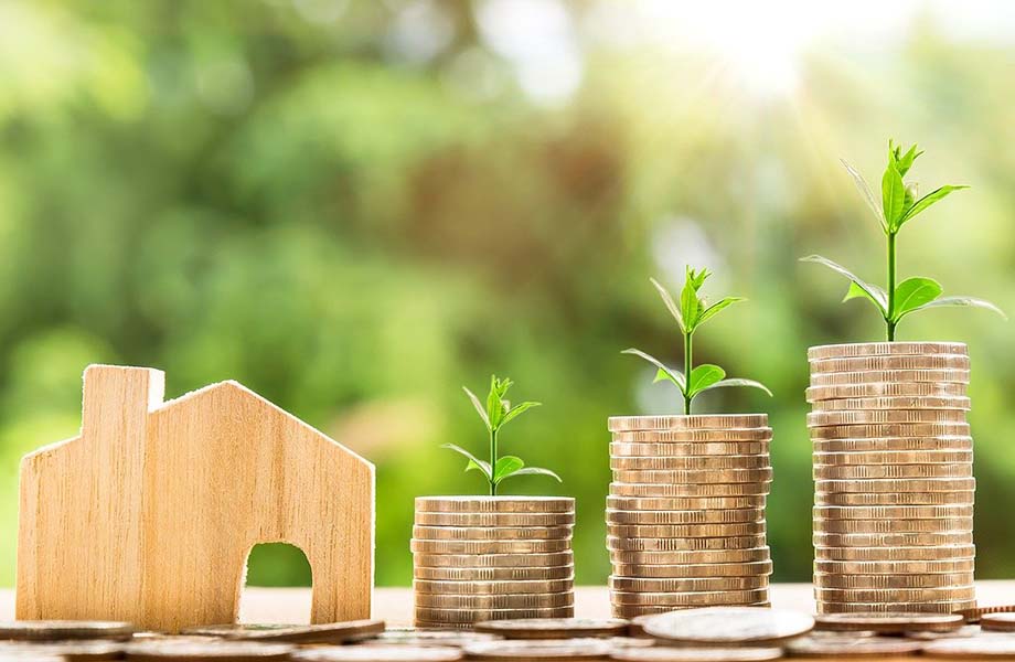 Little wooden home next to piles of coins - Image by Nattanan Kanchanaprat from Pixabay